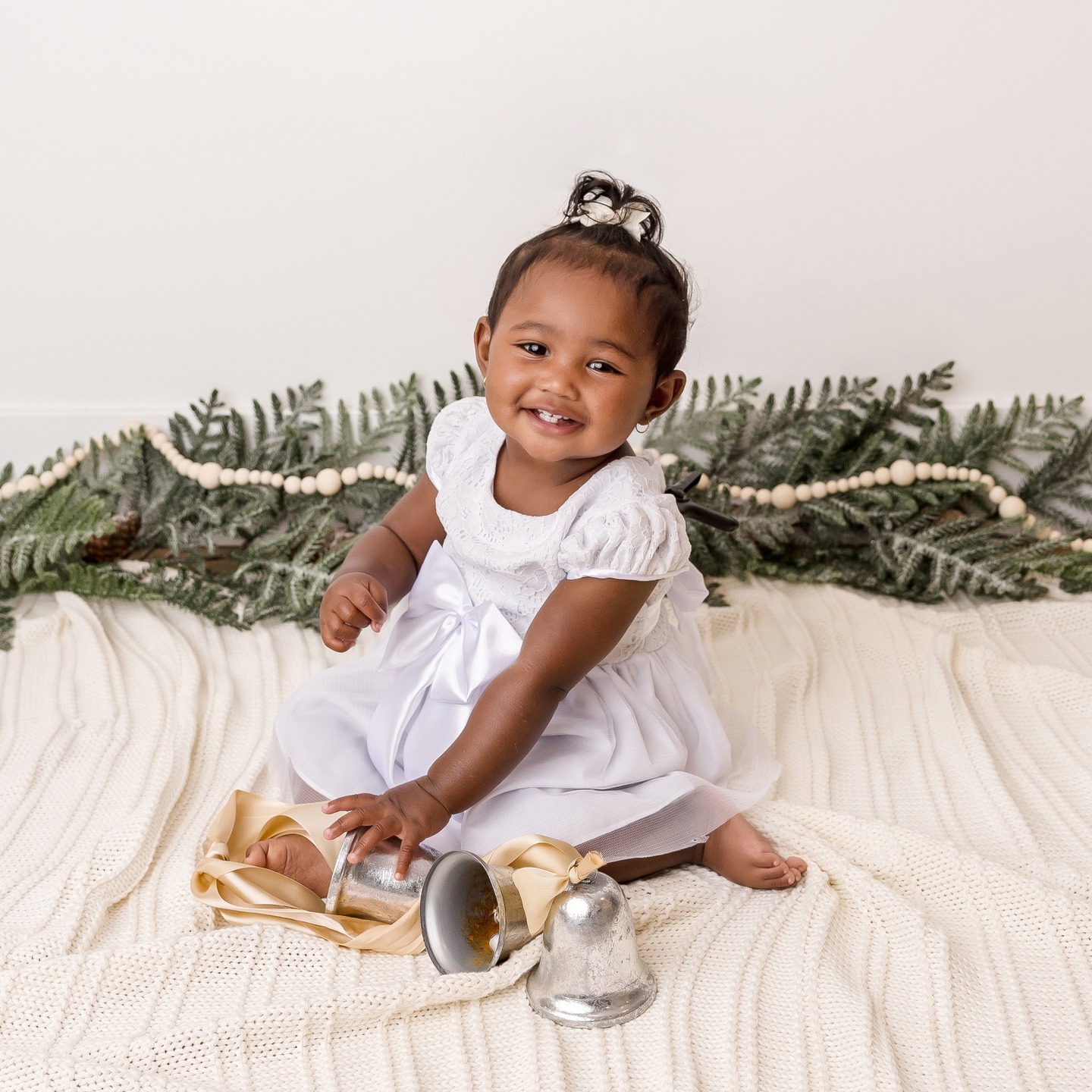 Newborn baby lying on soft blanket with greenery accents in a natural lifestyle photography session in Victoria BC